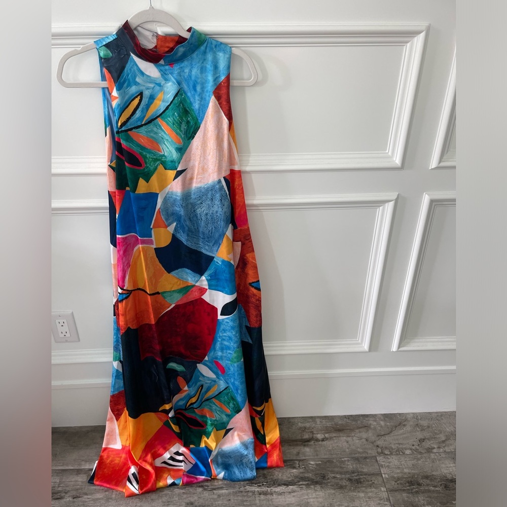 Floor length, colorful sleeveless dress.